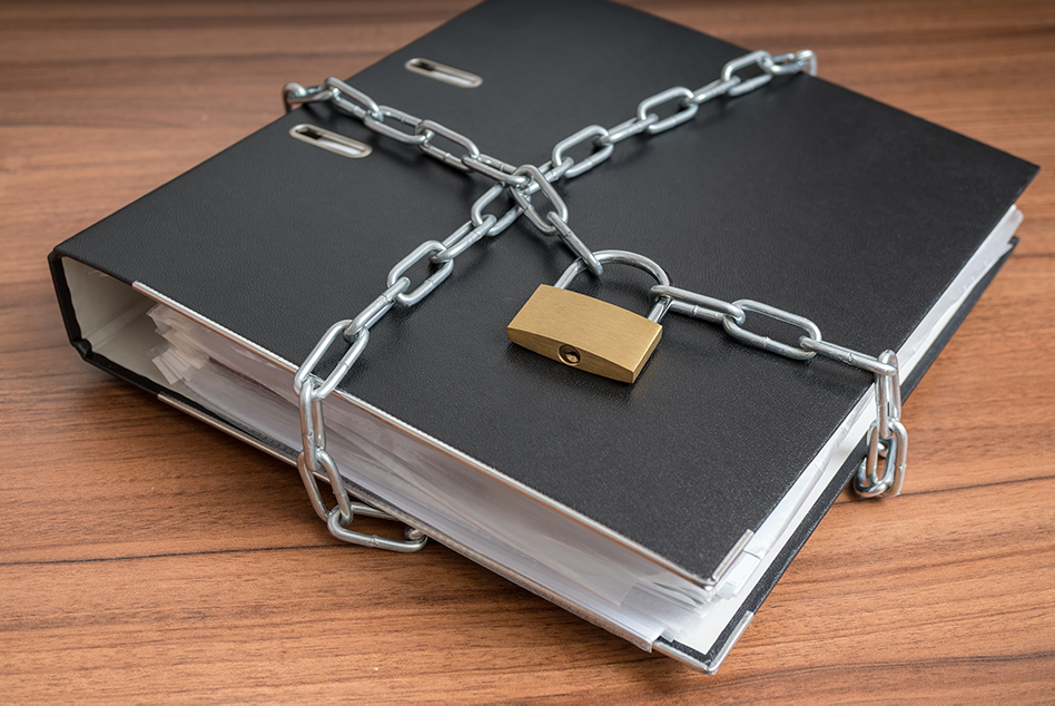a binder full of documents chained up and padlocked