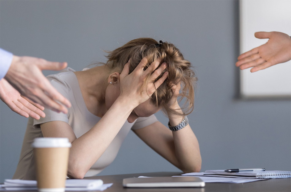 a stressed female employee being lectured by her managers